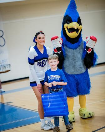 The St. Edmund Crown Bearers for homecoming this year were named. Thomas Andrus, a first grader, in front, has been chosen. The St. Ed mascot is Joe Aucoin, a freshman.