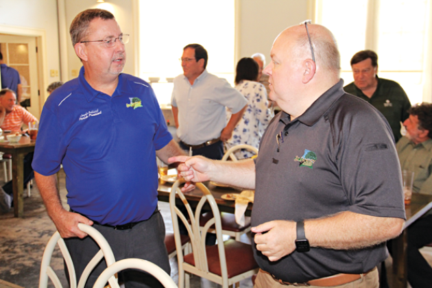 St. Landry Parish President Jessie Bellard, left, and Van Reed, parish emergency preparedness director, speak after Wednesday’s Eunice Rotary Club meeting. Bellard spoke at the meeting. At far right in the background is retired judge Ellis Daigle. (Photo by Harlan Kirgan)