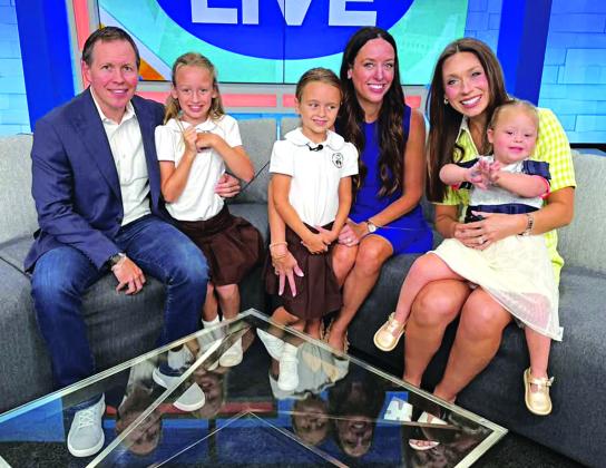 Emery Tanner is the daughter of Michael and Julia Tanner.  Michael is a Eunice native and is the son of Brian and Becky Tanner of Eunice. Also shown are siblings 9-year-old Ryleigh Tanner and 6-year-old Ainsley Tanner. Acadiana Live anchor Taylor Trache, right, holds Emery.