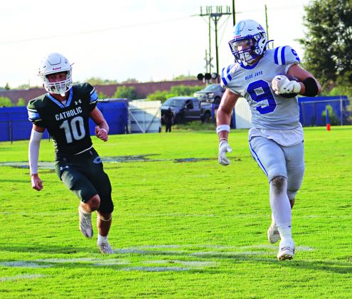 Max Smith, a sophomore tight end, evades a Catholic Pointe Coupee defender in the joe Nagata Jamboree. (Photos by Amy Myers)
