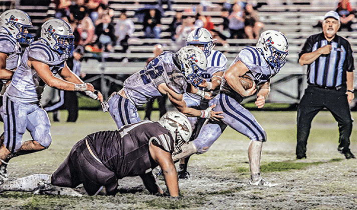 Blue Jay running back Henry Summerlin races through the Elton defense on the way to a 45-15 victory on a muddy field. (Photo by Dwight Jodon)