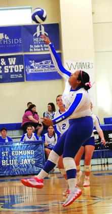 St. Edmund’s Reagan Gradney spikes the ball over the net in a match with DeQuincy. St. Edmund won all three sets 25-16, 25-21, 25-10. (Photo by Amy Myers)