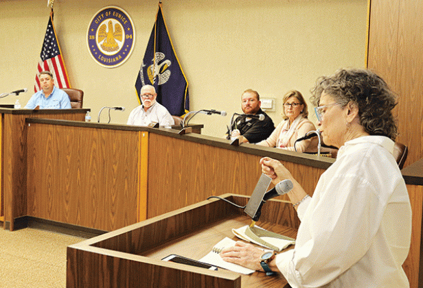 St. Landry Parish School Board member Mary Ellen Donatto speaks at the Eunice city meeting Tuesday about obtaining a Eunice Police officer as a school resource officer for Eunice public schools. Donatto is the District 13 representative to the School Board. The Eunice Board of Aldermen approved an agreement with the School Board for an officer. Shown, seated from left, are Mayor Scott Fontenot, Alderman at-large Marion “Nootsie” Sattler, Alderman Randy Reed and Alderwoman Connie Thibodeaux. (Photo by Harlan