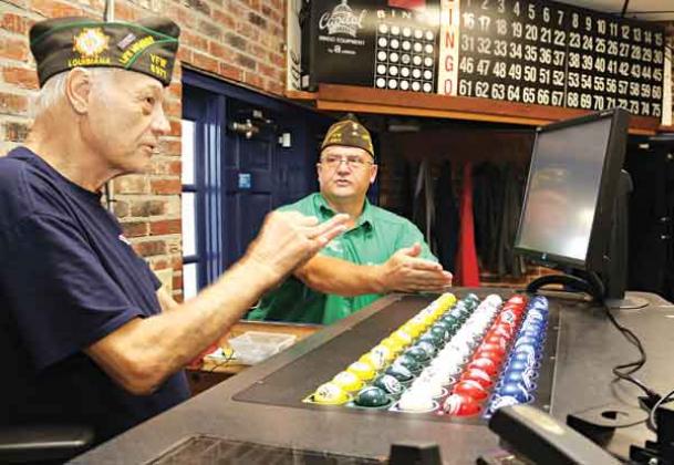 The progressive jackpot at the VFW Post 8971 bingo has reached $10,000. Bingo games are held on Thursdays and Sundays. Explaining the game, from left, are Donald Estillette, post chaplain, and Donnie Fontenot, post commander. (Photo by Harlan Kirgan)