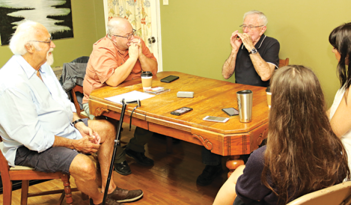 Jerry Devillier, third from left, makes a point using his harmonica during an interview for a UL Lafayette traditional music class. The interview is to be included in archives at UL Lafayette. From left, are Michael Doucet, Dr Chad Huval, Devillier, Renee Reed and Julie Babineaux. (Photos by Harlan Kirgan)