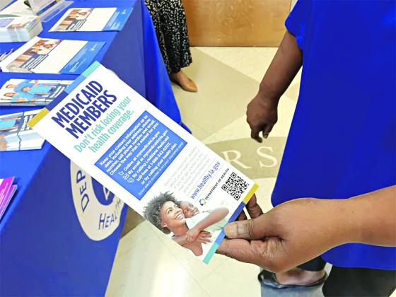 Chenita LeBlanc, a program manager with DePaul Community Health Center, holds a flyer for Louisiana Medicaid members in May. (Michelle Liu/Verite)