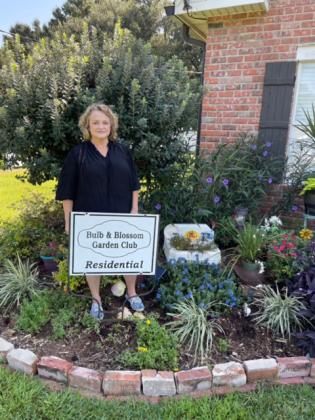 Bulb &amp; Blossom Garden Club volunteer Christie M. Spekschate selected as Residential Garden of the Month Angela and Willie Johnson at 300 Hill Street. The lawn features flowering beds of Mexican petunia, lantana, purple queen, drift roses, sweet potato vines and creeping Jenny.