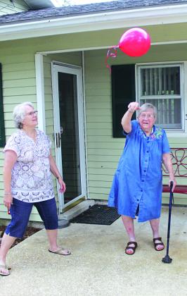Irma Boulet Darphin sets one of her birthday balloons loose. Darphin was born on Aug. 8, 1922, and her family recently hosted her 100th birthday party at her home.