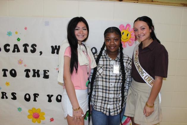 At left, Kaila Cuellar, a sophomore; Ja’Kya Patton, a freshman; and Alexis Ortego, a senior; dress for homecoming week. Tuesday was declared Country Club or Country.