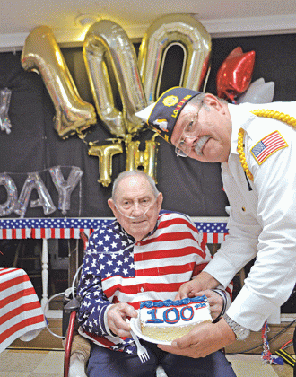 World War II and U.S. Navy Veteran Joe Richard of Church Point is presented with a slice of birthday cake by American Legion Post 225 Commander Dennis Hart during Richard’s 100th birthday party on July 23. Richard, Louisiana’s last known Pearl Harbor survivor, according to the Louisiana Department of Veterans Affairs, passed away Wednesday, just two months after his 100th birthday. (Photo by Claudette Olivier/Church Point News)