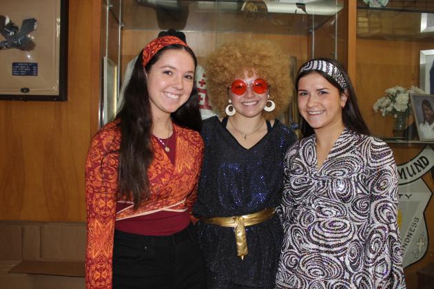 All is Groovy at St. Edmund High School Tuesday as students dressed up for Decades Day. From left, are sophomores Blair Heinen, Ava Smith and Sara Feucht.