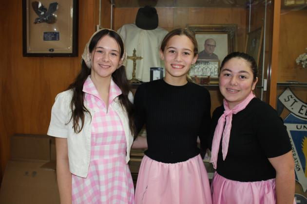 St. Edmund High freshmen students Ruby Durham, left, Reese Fruge and Amelie Fontenot dress Tuesday for Decades Day to celebrate homecoming week.