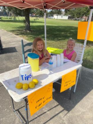 From left are Rose Mary Cleland, and Nora Kate Cleland, operated a lemonade stand this summer to raise money for a leukemia young boy. (Submitted photo)