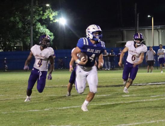 St. Ed’s Nathan Driggs, No. 4, running back and kicker, runs the ball during Friday evening’s match up against Opelousas Catholic Vikings. Driggs was a bright spot for St. Edmund all night, finishing with 144 rushing yards on 23 carries. (Photo by Amy Myers)