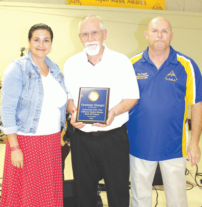Courtney Granger, center, is awarded the Hall of Fame Award by CFMA National Board President Troy Fontenot, right, during the 2023 CFMA Music Festival held at the Rayne Civic Center. Angelle Bellard, left, accepted on behalf of Steve Riley, the second Hall of Fame honoree.