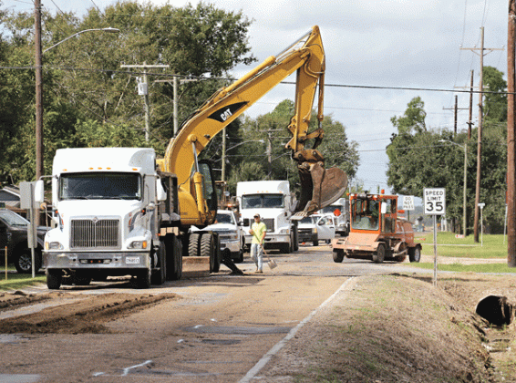 Crews work on Maple Avenue near Champagne’s on Friday morning. (Photo by Harlan Kirgan)