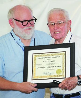Jerry Devillier, right, was recognized as a Louisiana Tradition Bearer during Festivals Acadiens et Créoles on Saturday in Lafayette. Presenting the certificate is John Sharp, assistant director for research at Center for Louisiana Studies, University of Louisiana-Lafayette. Devillier, 86, of Eunice, was described as the “...only one true Cajun harmonica player” during the ceremony. (Photos by Harlan Kirgan)
