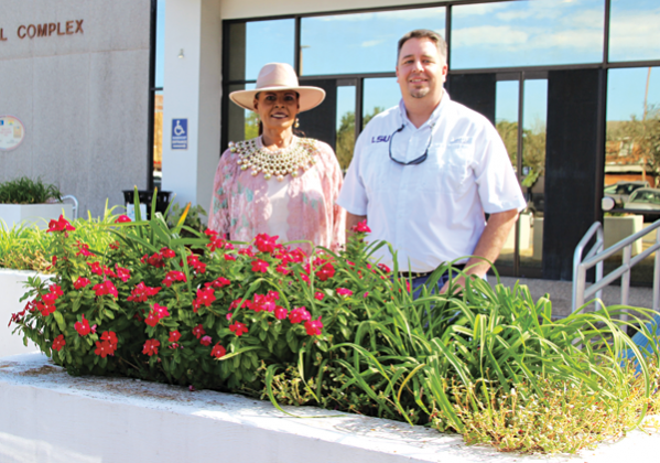 Angelia Guillory, community service supervisor, and Mayor Scott Fontenot by a flower box in front of the Eunice Municipal Complex. (Photo by Myra Miller)