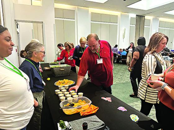 Attendees of the LSU AgCenter’s seventh annual Louisiana Farm to School Conference sample local satsumas provided by Ben & Ben Becnel Inc. (Photo by Jacey Wesley/LSU AgCenter) 