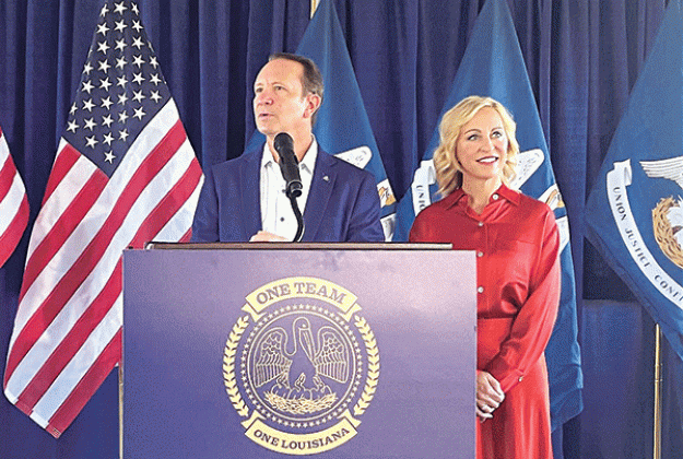 Gov.-elect Jeff Landry and his wife, Sharon, address reporters Oct. 25, 2023, at M.L. “Tigue” Moore Field at the University of Louisiana in Lafayette. (Piper Hutchinson/Louisiana Illuminator)