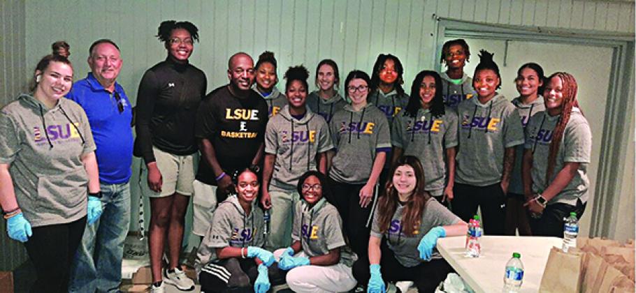 The LSUE Lady  Bengals Basketball team volunteered Wednesday for the ECHC Sausage PoBoy fundraiser held at the VFW Bobcat Hall on Bobcat Drive. Above are the team members, coaches, and Randall Vigee, a volunteer and supporter of the Eunice Community Health Center. (Photo by Glynn Michaud)