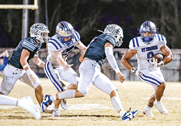 St. Edmund’s Marcus Gradney works to avoid a Catholic-Pointe Coupee pursuit in the 26-22 loss on Oct. 24. (Photo by Dwight Jodon)