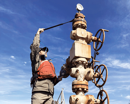 A U.S. Fish and Wildlife Service worker tests an abandoned well in Lacassine National Wildlife Refuge near Lake Charles. (USFWS photo)