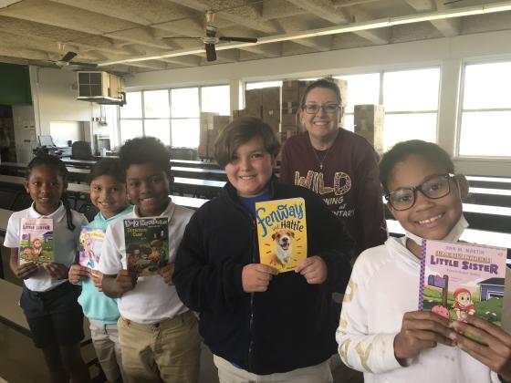 Free book winners from a drawing at East Elementary are third and fourth graders. From left, are Abriona Vallaire, Harlee Dupre, Travis Reed, Austen Fontenot, Principal Gina LaGrange and Meeyah Celestine. Not pictured is Sophia Rideau.