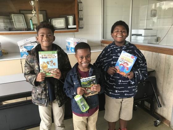 Free book winners from a drawing at East Elementary are second graders Chase Williams, left, Tez Holness and Kadari Vories.