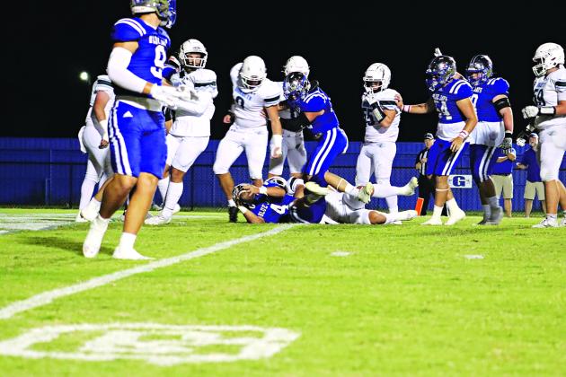 St. Edmund’s Nathan Driggs, No. 4, running back and kicker, makes the first touchdown of the evening during last Friday’s over time win of 52-50 over Catholic-Pointe Coupee. (Photo by Amy Myers)