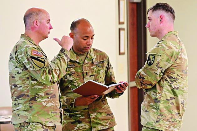 Louisiana National Guardsmen from multiple units compare notes during a break at the annual Hurricane Rehearsal of Concept (ROC) Drill at the Armed Forces Reserve Center in Baton Rouge on May 21. The ROC Drill provides a collaborative environment for refining emergency response plans and improving coordination across commands. (U.S. Army National Guard photo by Capt. Peter Drasutis)
