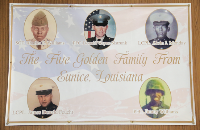 A banner in the lobby of the Eunice Municipal Complex honors five men killed in action during the Vietnam War. Shown, clockwise from bottom left, are Lance Cpl. James Feucht, Sgt. Charles Williams, Pfc. Donald Sistrunk, Lance Cpl. Alvin Monday and Pfc. Jimmy Williams. The banner does not include Pfc. Andrus Duplechain. (Photo by Harlan Kirgan)