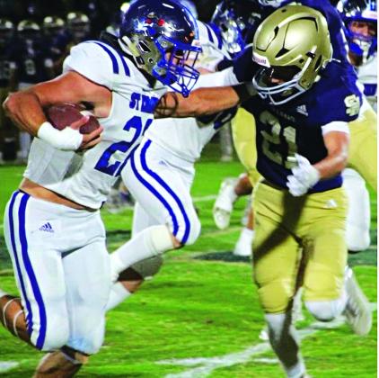 St. Ed’s Wyatt Dubois stiff arms a Sacred Heart defender on the way to scoring a touchdown in last Friday’s 58-36 win over the Trojans in district play. (Photo by Sports Editor Rhett Manuel)