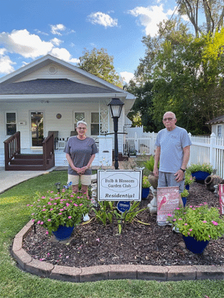Doug and Tracey Patterson are the latest recipients of the Residential Yard of the Month presented by the Bulb and Blossom Club of Eunice. Their home at 401 W. Gum features pink vincas, pink and yellow hibiscus and foxtail ferns in neat blue containers along with amaryllis and agapanthus planted in their front flower bed. Pictured are Tracey and Doug Patterson.