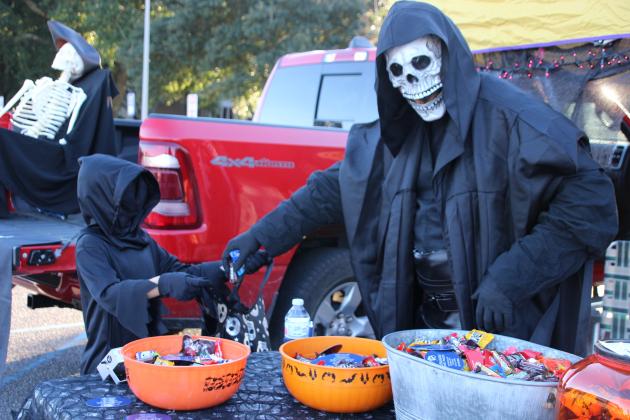 Dr. Hawk Cambron with the Louisiana Family Practice hands out candy to Blaise Bellon, 7.