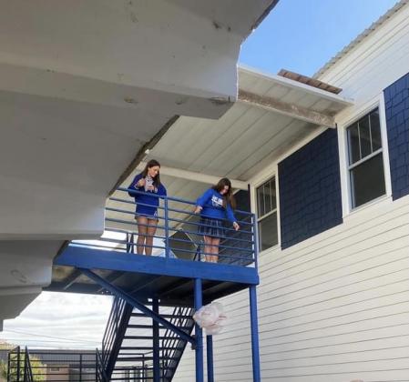 St. Edmund students Milly Miller, left and Emma Myers, in Clay Harper’s physical science class, conducted an Egg Drop Experiment while studying Sir Isaac Newton’s Laws of Motion. The girls watched their experiment from a high advantage point.