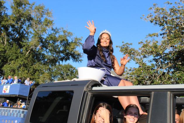 Last year’s St. Edmund Homecoming Queen Millie Miller waves to the parade crowd during St. Ed’s traditional Homecoming Parade Friday.