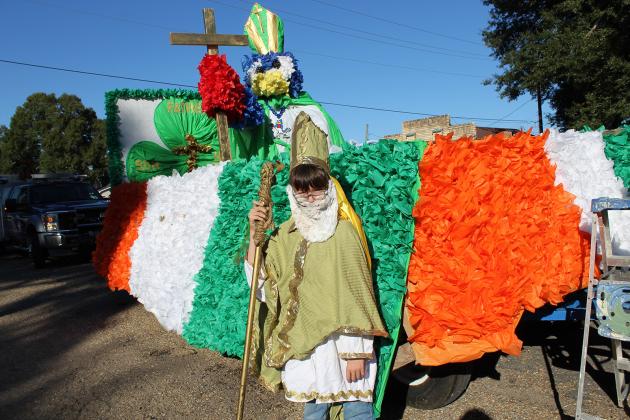 This year’s theme for the St. Edmund Homecoming parade was “Saints.” Michael Smith, a fourth grader, stands in front of his class float, “Father, Son &amp; Holy Spirit.”
