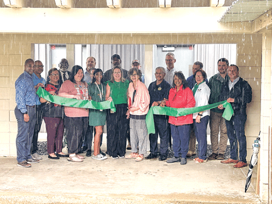 The rain was pouring down during a ribbon-cutting ceremony to celebrate new restrooms at East Elementary in Eunice on Wednesday. Among those present were St. Landry Parish School Superintendent Milton Batiste III, assistant superintendents, several School Board members, Lemoine Company representative, and the instructional leadership team of East Elementary. At the center of the photo, cutting the ribbon is School Board President Mary Ellen Donatto and Principal Gina LaGrange. The new restrooms are funded b
