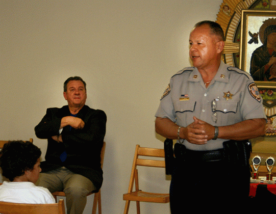 St. Landry Parish Sheriff's DARE officer Theme Ledee, right, is shown during a program at St. Edmund Elementary School in 2009. At left, seated, is Sheriff Bobby Guidroz. (File photo)