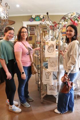 While Noel shopping with her niece, Emma Myers, left, Amanda McGee met up with a classmate, Racheal Manuel, who was also at The Iron Gate early to find the best deals.