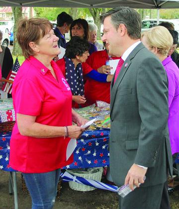 U.S. Rep. Mike Johnson, right, visits with local Catholic Daughters of America Regent Fannie Soileau outside the Evangeline Parish Courthouse on Nov. 11 during a Veterans Day event. (Ville Platte Gazette photo by Tony Marks)