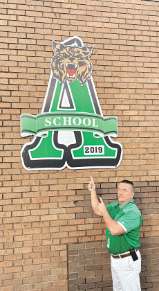 Eunice High School Principal Mitch Fontenot is with a giant A at the school marking its 2019 ranking as an A school in the performance scores. Eunice High scored its fourth A in a row in the annual scores released on Wednesday. (Submitted photo)