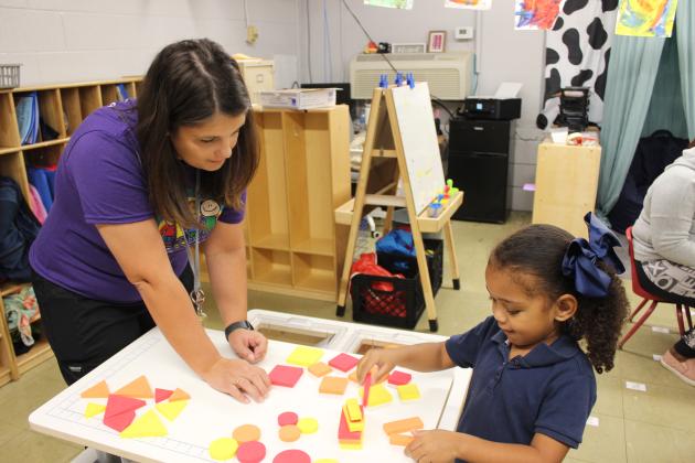 Dakota Frey, a new teacher, is with A’riyah Kennedy, a pre-k student, at Highland Early Learning Center during a recent Come Learn With Me classroom session.