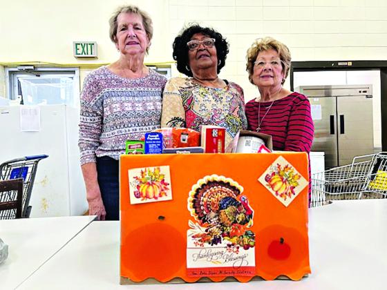 Beta Sigma Phi Sorority donated canned goods and presented a monetary donation to Mary Ann Guillory, director at the Eunice Food Bank.