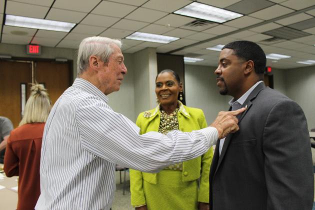 Don Mayeux, left, Angelia Guillory and State Representative Dustin Miller converse before the meeting at the Eunice Rotary Club meeting Wednesday. Mayeux is admiring Miller’s House of Representative pin. Miller was Guillory