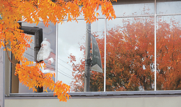 The fall color is mixed with Santa Claus in the St. Landry Bank second-floor window.
