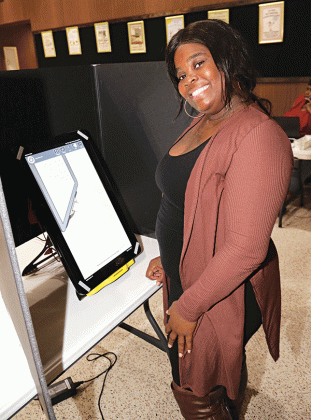 Trovette Martin, a clerk at the Eunice City Hall poll, waits for voters Tuesday afternoon. (Photo by Harlan Kirgan)