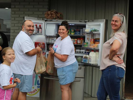 Stocking the refrigerator that is located at Tri Parish Electrical Supply are from left Molly Fontenot, Brad Richard, Jennifer Fontenot and Brooke Lafleur.  This community fridge is opened to anyone in need at the location of Tri Parish Electrical Supply at 101 West Walnut. (Photo by Myra Miller)