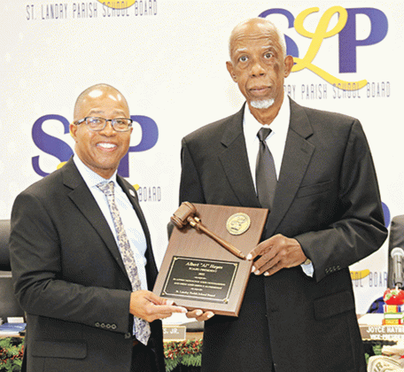Albert Hayes Jr., right, accepts a plaque from St. Landry Parish school superintendent, recognizing his year as president of the St. Landry Parish School Board. (Photo by Harlan Kirgan)